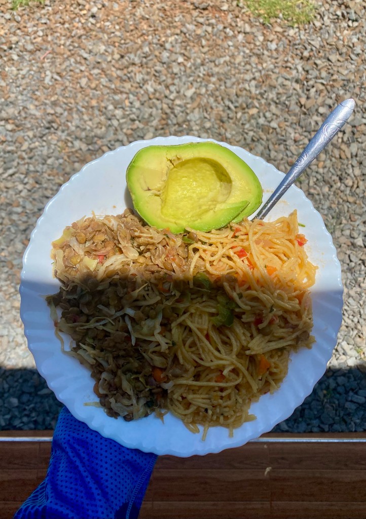 A camp plate with avocado, lentils and spaghetti
